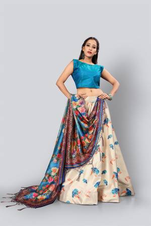 Look Beautiful Wearing This Designer Lehenga Choli In Blue Colored Blouse And Dupatta Paired With A Contrasting Cream Colored Lehenga. This Digital Printed Lehenga Choli Is Fabricated On Satin Silk Paired With Assam Silk Fabricated Dupatta.