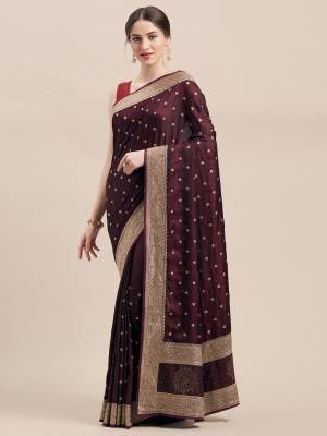 Flaunt Your Rich And Elegant Taste Wearing This Designer Saree In Wine Color Paired with Wine Colored Blouse. This Detailed Embroidered Saree And Blouse Are Satin Silk Based Which Also Gives A Rich Look To Your Personality. 