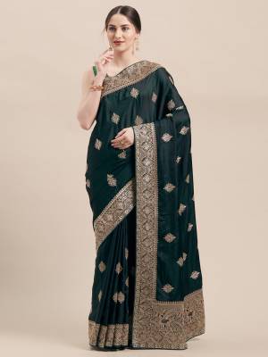 You Will Definitely Earn Lots Of Compliments Wearing This Designer Embroidred Saree In Pine Green Color Paired With Same Pine Green Colored Blouse. This Saree And Blouse Are Fabricated On Satin Silk Which Is Light Weight, Durable And Easy To Carry Throughout The Gala. 