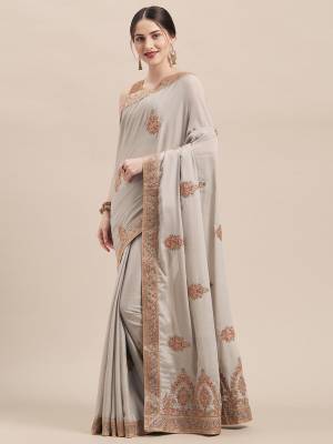 Get Ready For The Upcoming Wedding And Festive Season With This Very Beautiful Designer Saree In Elegant Pale Grey Color Paired With Pale Grey Colored Blouse. This Saree And Blouse Are Fabricated On Chinon Silk Beautified With Jari & Thread Embroidery Highlighted With Stone Work. Its Pretty Elegant Color And Rich Fabric Will Earn You Lots Of Compliments From Onlookers. 