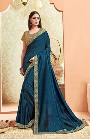Here Is A Rich And Elegant Looking Designer Saree In Blue Color. This Pretty Elegant Silk Based Saree Is Plain With Embroidered Border And Heavy Embroidered Blouse.  Its Rich Color And Elegant Pattern Will Earn You Lots Of Compliments From Onlookers. 