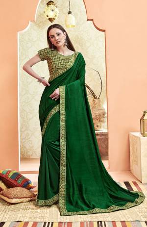 Here Is A Rich And Elegant Looking Designer Saree In Green Color. This Pretty Elegant Silk Based Saree Is Plain With Embroidered Border And Heavy Embroidered Blouse.  Its Rich Color And Elegant Pattern Will Earn You Lots Of Compliments From Onlookers. 