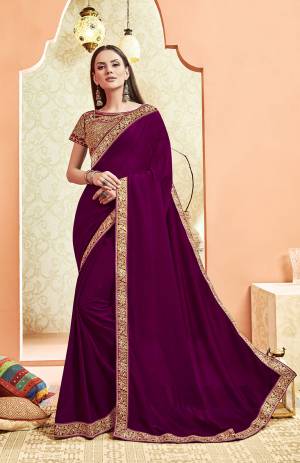 Here Is A Rich And Elegant Looking Designer Saree In Wine Color. This Pretty Elegant Silk Based Saree Is Plain With Embroidered Border And Heavy Embroidered Blouse.  Its Rich Color And Elegant Pattern Will Earn You Lots Of Compliments From Onlookers. 
