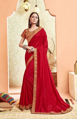 Here Is A Rich And Elegant Looking Designer Saree In Red Color. This Pretty Elegant Silk Based Saree Is Plain With Embroidered Border And Heavy Embroidered Blouse.  Its Rich Color And Elegant Pattern Will Earn You Lots Of Compliments From Onlookers. 