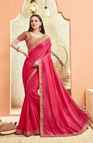 Here Is A Rich And Elegant Looking Designer Saree In Rani Pink Color. This Pretty Elegant Silk Based Saree Is Plain With Embroidered Border And Heavy Embroidered Blouse.  Its Rich Color And Elegant Pattern Will Earn You Lots Of Compliments From Onlookers. 