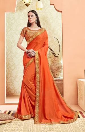 Here Is A Rich And Elegant Looking Designer Saree In Orange Color. This Pretty Elegant Silk Based Saree Is Plain With Embroidered Border And Heavy Embroidered Blouse.  Its Rich Color And Elegant Pattern Will Earn You Lots Of Compliments From Onlookers. 
