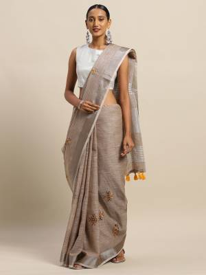 Flaunt Your Rich And Elegant Taste Wearing This Designer Saree In Dark Grey Color Paired With Dark Grey Colored Blouse. This Elegant Looking Saree And Blouse Are Fabricated On Linen Cotton Which Has Rich Feel And Beautified With Thread Embroidery. Buy This Pretty Saree Now.