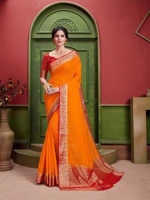 You Will Definitely Earn Lots Of Compliments Wearing This Pretty Orange Colored Saree Paired With Contrasting Red Colored Blouse. This Saree And Blouse Are Fabricated On Art Silk Beautified With Detailed Weave. Buy This Saree Now.