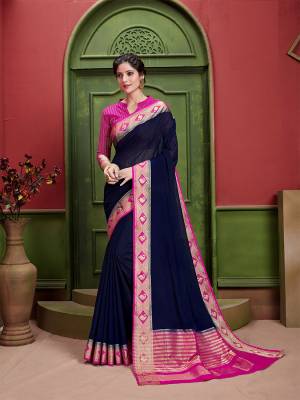 Enahnce Your Personality Wearing This Lovely Designer Saree In Navy Blue Color Paired With Contrasting Rani Pink Colored Blouse. This Saree and Blouse Are silk Based Which Gives A Rich Look To Your Personality. 