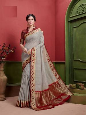Add This Pretty Elegant Looking Saree To Your Wardrobe In Grey Color Paired With Maroon Colored Blouse. This Saree And Blouse Are Fabricated On Art Silk Which Is Durable And Gives A Pretty Rich Look. 