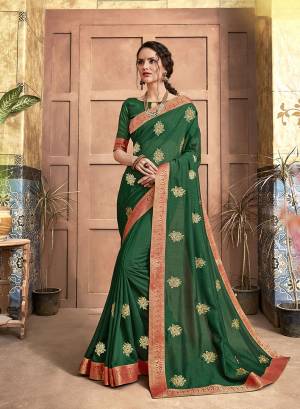 Add This Pretty Simple And Elegant Looking Designer Saree To Your Wardrobe In Dark Green Color. This Saree And Blouse Are Silk Based Beautified With Small Embroidered Motifs. 
