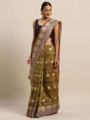 Celebrate This Festive Season With Beauty And Comfort Wearing This Designer Saree In Olive Green Color Paired with Contrasting Brown Colored Blouse. This Saree and Blouse Are Fabricated On Cotton Handloom Which Gives A Rich Look To Your Personality. 