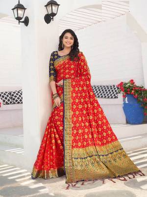 For A Proper Traditional Wear, Grab This Designer Silk Based Saree In Red Color Paired With Contrasting Navy Blue Colored Blouse. This Saree Is Fabricated On Nylon Crepe Silk Paired With Art Silk Fabricated Blouse. It Is Beautified With Heavy Weave All Over. 