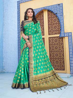 For A Proper Traditional Wear, Grab This Designer Silk Based Saree In Sea Green Color Paired With Contrasting Navy Blue Colored Blouse. This Saree Is Fabricated On Nylon Crepe Silk Paired With Art Silk Fabricated Blouse. It Is Beautified With Heavy Weave All Over. 