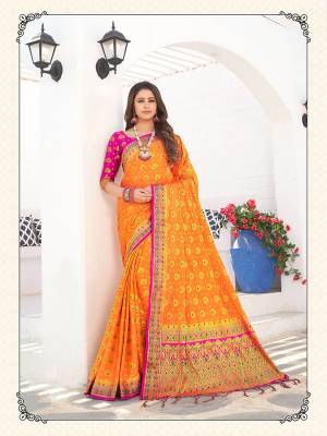 For A Proper Traditional Wear, Grab This Designer Silk Based Saree In Orange Color Paired With Contrasting Rani Pink Colored Blouse. This Saree Is Fabricated On Nylon Crepe Silk Paired With Art Silk Fabricated Blouse. It Is Beautified With Heavy Weave All Over. 