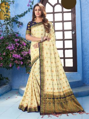 For A Proper Traditional Wear, Grab This Designer Silk Based Saree In Cream Color Paired With Contrasting Navy Blue Colored Blouse. This Saree Is Fabricated On Nylon Crepe Silk Paired With Art Silk Fabricated Blouse. It Is Beautified With Heavy Weave All Over. 