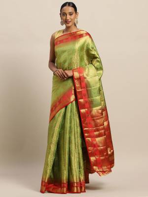 Rich And Elegant Looking Designer Silk Based Saree Is Here In Light Green Color Paired With Contrasting Red Colored Blouse. This saree And Blouse Are Fabricated On Art Silk Which Gives A Rich Look To Your Personality. 
