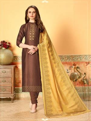 Celebrate This Festive Season Wearing This Designer Dress Material In Brown Color Paired With Contrasting Occur Yellow Colored Dupatta. Its Top Is Silk Based Beautified With Embroidery And Self Butti Paired With Santoon Bottom and Jacquard Cotton Silk Dupatta.