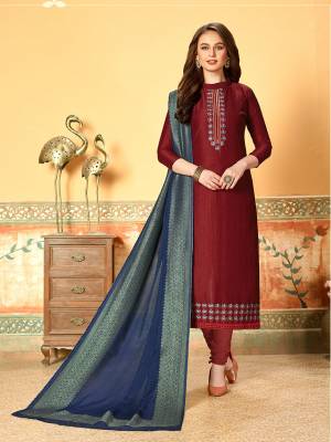 Grab This Very Beautiful Designer Dress Material In Maroon Color Paired With Contrasting Navy Blue Colored Dupatta. Its Pretty Embroidered Top Is Fabricated On Art Silk With Self Butti Paired With Santoon Bottom And Jacquard Cotton Silk Dupatta. Buy This Straight Suit Now. 