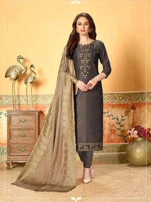 Celebrate This Festive Season Wearing This Designer Dress Material In Dark Grey Color Paired With Contrasting Pale Grey Colored Dupatta. Its Top Is Silk Based Beautified With Embroidery And Self Butti Paired With Santoon Bottom and Jacquard Cotton Silk Dupatta.