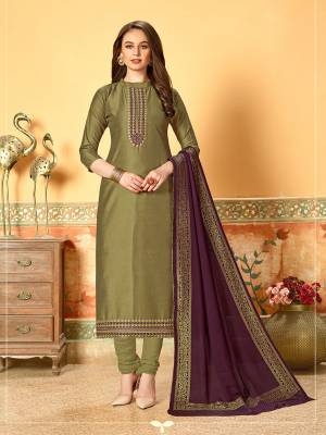 Grab This Very Beautiful Designer Dress Material In Olive Green Color Paired With Contrasting Purple Colored Dupatta. Its Pretty Embroidered Top Is Fabricated On Art Silk With Self Butti Paired With Santoon Bottom And Jacquard Cotton Silk Dupatta. Buy This Straight Suit Now. 