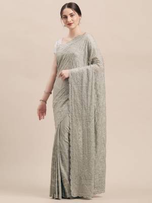 You Will Definitely Earn Lots Of Compliments Wearing This Heavy Designer Saree In Grey Color Paired With Grey Colored Blouse. This Pretty Saree And Blouse Are Fabricated On Georgette. This Saree Is Beautified With Heavy Detailed Tone To Tone Embroidery All Over. 
