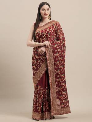 Get Ready For The Upcoming Wedding Season With This Heavy Embroidred Designer Saree In Maroon Color. This Saree Is Fabricated On Georgette Paired With Art Silk Fabricated Blouse. By This Pretty Saree Now.