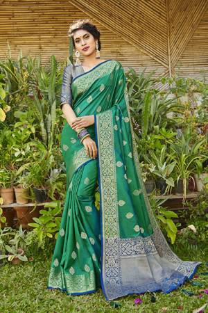 You Will Definitely Earn Lots Of Compliments Wearing This Designer Silk Based Saree In Sea Green Color Paired With Royal Blue Colored Blouse. It Is Beautified With Weave Giving An Attractive Look. 