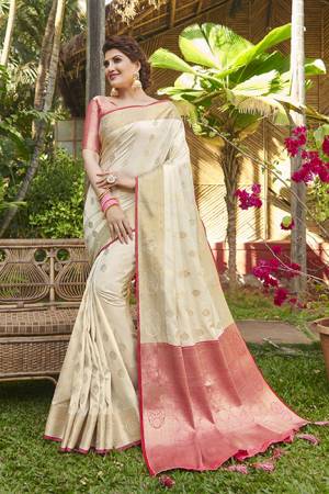 Here Is A Very Pretty Heavy Weaved Designer Saree In Cream Color Paired With Dark Pink Colored Blouse. This Saree And Blouse Are Silk Based And Is Suitable For Festive Or Occasion Wear. Buy Now.