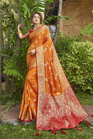 Here Is A Very Pretty Heavy Weaved Designer Saree In Orange Color Paired With Red Colored Blouse. This Saree And Blouse Are Silk Based And Is Suitable For Festive Or Occasion Wear. Buy Now.