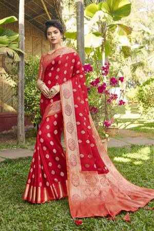 You Will Definitely Earn Lots Of Compliments Wearing This Designer Silk Based Saree In Red Color Paired With Orange Colored Blouse. It Is Beautified With Weave Giving An Attractive Look. 