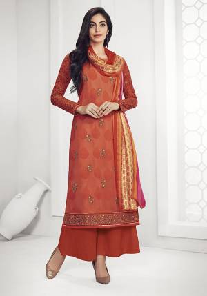 Get This Pretty Designer Semi-Stitched Suit In Rust Orange Color. Its Top Is Georgette Based Beautified With Embroidery Paired With Plain Santoon Bottom and Satin Dupatta. Buy This Straight Suit Now.