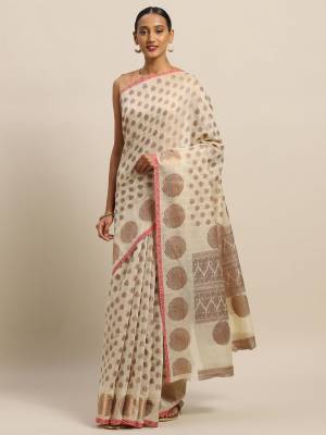 Simple And Elegant Looking Designer Weaved Saree Is Here In Cream?Color Paired With Brown And Cream Colored Embroidered Blouse. This Saree And Blouse Are Fabricated On Handloom Silk Which Is Durable, Light Weight And Easy To Care For.