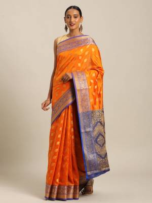 Simple And Elegant Looking Designer Weaved Saree Is Here In Orange?Color Paired With Contrasting Blue Colored Embroidered Blouse. This Saree And Blouse Are Fabricated On Handloom Silk Which Is Durable, Light Weight And Easy To Care For.