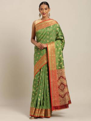 Simple And Elegant Looking Designer Weaved Saree Is Here In Green?Color Paired With Contrasting Red Colored Embroidered Blouse. This Saree And Blouse Are Fabricated On Handloom Silk Which Is Durable, Light Weight And Easy To Care For.