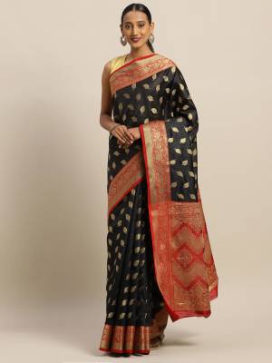 Simple And Elegant Looking Designer Weaved Saree Is Here In Black?Color Paired With Contrasting Red Colored Embroidered Blouse. This Saree And Blouse Are Fabricated On Handloom Silk Which Is Durable, Light Weight And Easy To Care For.