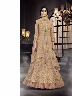 Here Is A Very Beautiful Heavy Designer Indo-Western Suit In All Over Light Peach Color Which Also Comes With An Attractive Embroidered Cape. This Beautiful Dress Is Net Based Beautified Heavy Detailed Embroidery. 