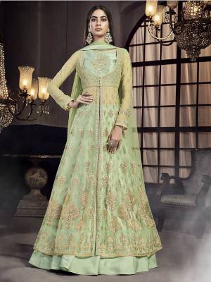 Here Is A Very Beautiful Heavy Designer Indo-Western Suit In All Over Light Green Color Which Also Comes With An Attractive Embroidered Cape. This Beautiful Dress Is Net Based Beautified Heavy Detailed Embroidery & Paired With A Satin Fabricated Skirt. 