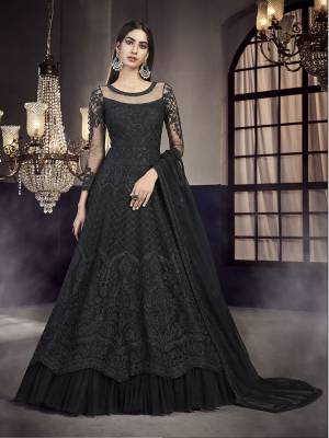 Flaunt Your Rich And Elegant Taste Wearing This Heavy designer Floor Length Suit In All Over Black Color. Its Top And Dupatta Are Net Based Paired With Santoon  Bottom. 