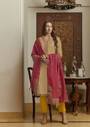New And Unique Styled Multi Colored Designer Straight Suit Is Here In Beige Colored Top Paired With Contrasting Yellow Colored Bottom and Dark Pink Colored Dupatta. Its Top Is Fabricated On Muslin Paired With Cotton Bottom And Its Dupatta Is Fabricated On Silk Handloom. 