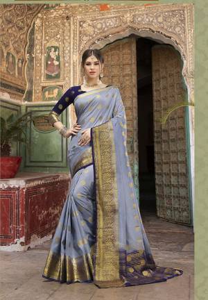 Adorn A Proper Traditional Look Wearing This Designer Silk Based Saree In Grey Color Paired With Navy Blue Colored Blouse. This Saree And Blouse Are Fabricated On Nylon Silk Beautified With Weave. 