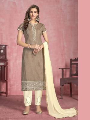 For Your Semi-Casuals, Get This Pretty Straight Suit In Light Brown Colored Top Paired With Cream Colored Bottom And Dupatta. Its Top Is Fabricated On Cotton Paired With Semi Lawn Bottom and Chiffon Dupatta. Buy This Semi-Stitched Suit Now.
