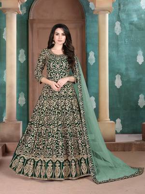Get Ready For The Upcoming Wedding Season With This Attractive Looking Heavy Designer Floor Length Suit In Dark Green Color. This Pretty Heavy Embroidered Suit Is Fabricated On Georgette Paired With Santoon Bottom And Net Fabricated Dupatta. Its Bright Color And Heavy Embroidery Will Give An Attractive Look To Your Personality. 