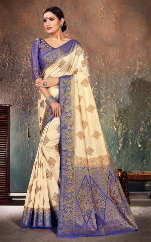Look Attractive In This Pretty Cream Colored Saree Paired With Royal Blue Colored Blouse. This Saree And Blouse Are Fabricated On Nylon Silk Beautified With Weave All Over. Buy This Saree Now.?