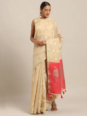 You Will Definitely Earn Lots Of Compliments Wearing This Pretty Elegant Looking Saree In Cream Color Paired With Dark Pink Colored Blouse. This Saree and Blouse Are Fabricated On Linen Cotton. It Is Light Weight, Durable And Easy To Care For. 