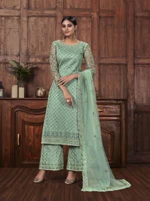 Get Ready For The Upcoming Festive And Wedding Season With This Designer Straight Suit In Sea Green Color Fabricated On Net. It Is Beautified With Heavy Embroidery Over Top, Bottom and Dupatta. 