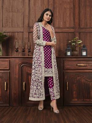 Here Is A Beautiful Heavy Embroidered Designer Suit In Wine Color Which Also Comes With A Heavy Embroidered Jacket, This Pretty Suit Is Net Based With Satin Inner. Buy This Semi-Stitched Suit Now.