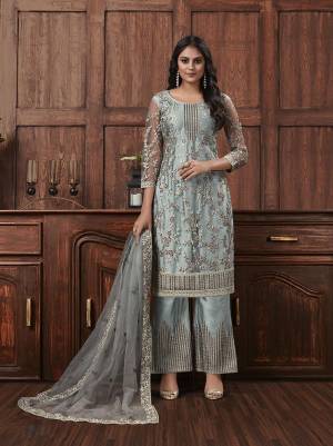 Here Is A Beautiful Heavy Embroidered Designer Suit In Grey Color Which Also Comes With A Heavy Embroidered Jacket, This Pretty Suit Is Net Based With Satin Inner. Buy This Semi-Stitched Suit Now.