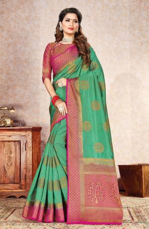 Celebrate This Festive Season In A Proper Traditional Look Wearing This Designer Weaved Saree In Sea Green Color Paired With Contrasting Dark Pink Colored Blouse. This Saree And Blouse Are Fabricated On Rich Nylon Silk. 