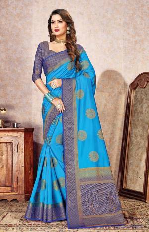 Celebrate This Festive Season In A Proper Traditional Look Wearing This Designer Weaved Saree In Blue Color Paired With Contrasting Navy Blue Colored Blouse. This Saree And Blouse Are Fabricated On Rich Nylon Silk. 